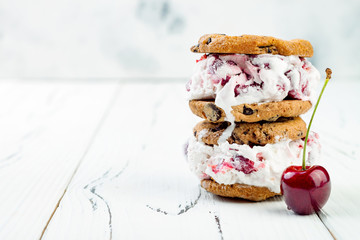 Homemade Black Forest roasted cherry ice cream sandwiches with chocolate chip cookies. Copy space