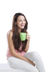 Young woman with a mug smiling