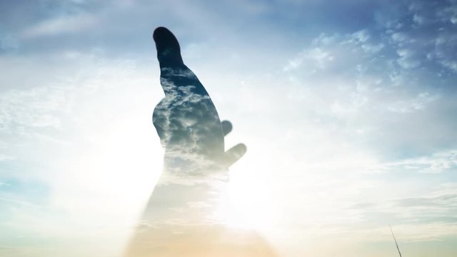 Double exposure men hand touches the sun.