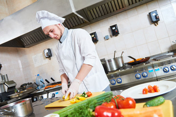 male chef cutting vegetables for salad food