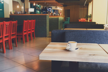 Modern restaurant interior, coffee cup on table