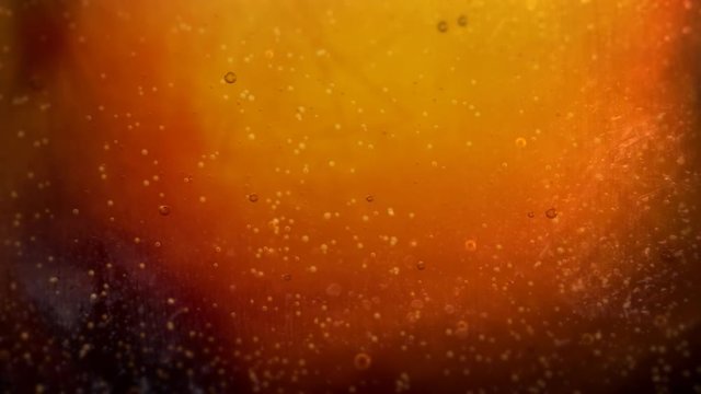 Pouring cola soda into Glass with Bubbles Background