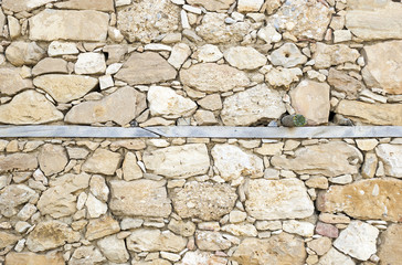 Fragment of the wall of a rural house made of natural stone