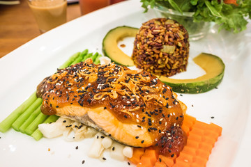 Salmon Steak Topped with Japanese Sauce and Fried Onion on Well Decorated Dish