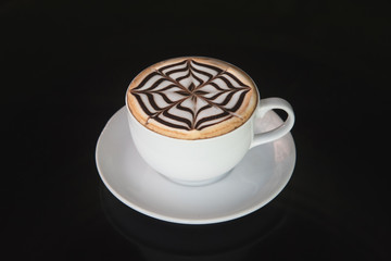 white cup of coffee on black background