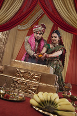 Obraz na płótnie Canvas Beautiful Indian couple during their wedding ceremony 