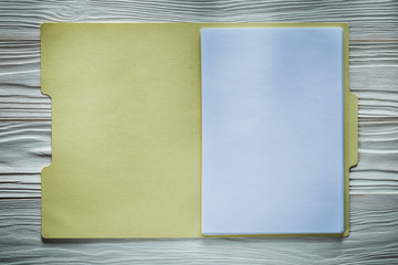 Office folder with blank paper on wooden board