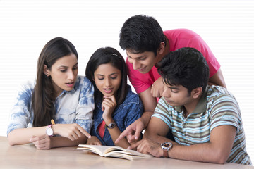 College students reading book in library