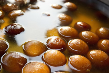 Gulab jamuns in syrup displayed at stall