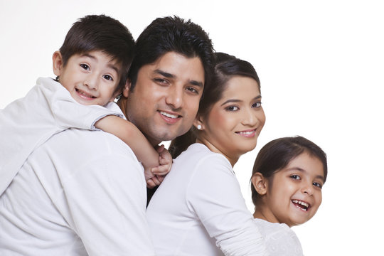 Portrait of smiling family over white background 