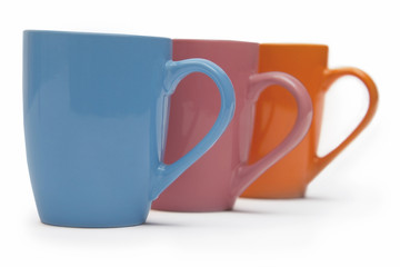 Colourful mugs in a row 