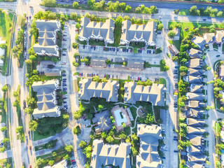 Aerial view typical multi-level apartment building next to residential houses neighborhood with...