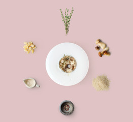 Cooking ingredients for italian risotto with wild mushrooms isolated on yellow