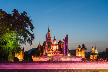Obraz premium Colorful light up buddha statue at wat mahathat temple in sukhothai world heritage thailand