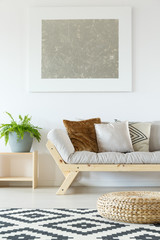 Beige couch, wood and fern