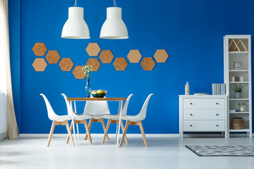 Fototapeta premium Blue walls and simple furniture