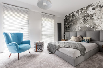 Bedroom with vintage blue armchair
