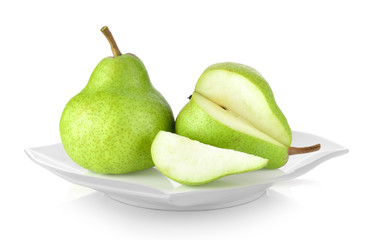 green pears in white plate on white background