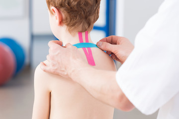 Professional doctor uses pink and blue tapes
