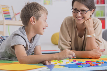Blonde boy lying on floor with woman © Photographee.eu