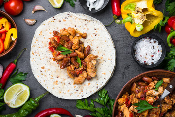 Cooking Mexican taco with meat beans and vegetables.