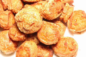 Deep fried meat rolls on white paper closeup shot