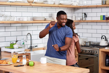 Couple dancing in kitchen