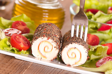 Goat cheese with salad and cherry tomatoes. 
