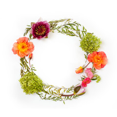 Floral round crown (wreath) with flowers and leaves. Flat lay, top view. Creative arrangement with roses, gray grefsheim leaves, sevenbark and waterlily.