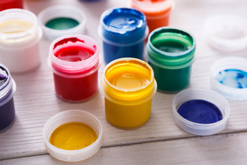 Artist workplace, set of color paints on wood desk