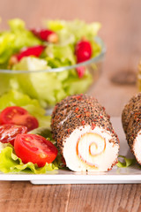 Goat cheese with salad and cherry tomatoes. 