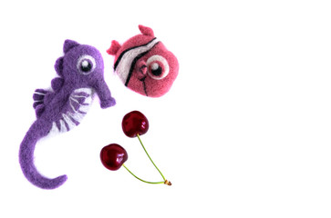 Pink fish and purple sea horse handmade wool and cherries Isolate on white background