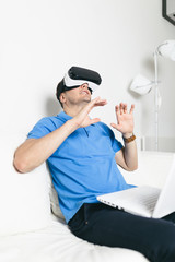 Young man using virtual reality headset or glasses.