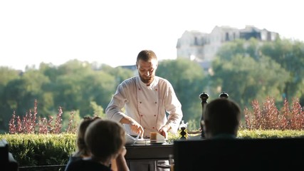 Show Kitchen. The cook prepares Carpaccio for the guests of the restaurant