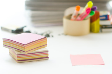On a white table colorful block for notes