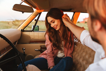 Young man flirting with his girlfriend by touching her hair