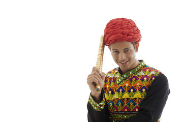 Fototapeta premium Portrait of a male dandiya dancer with sticks 