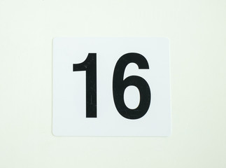 sixteen number sign on white paper