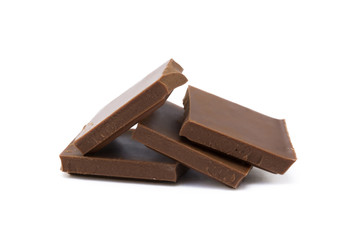 Milk chocolate pieces isolated on white background
