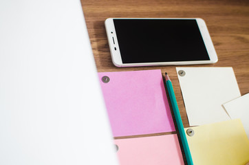 On my Desk a smartphone, a pencil, and paper for notes