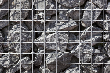 Wall of metal net with stones