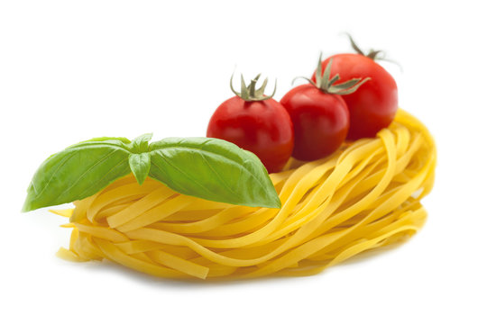 pasta basil and tomatoes on a white background