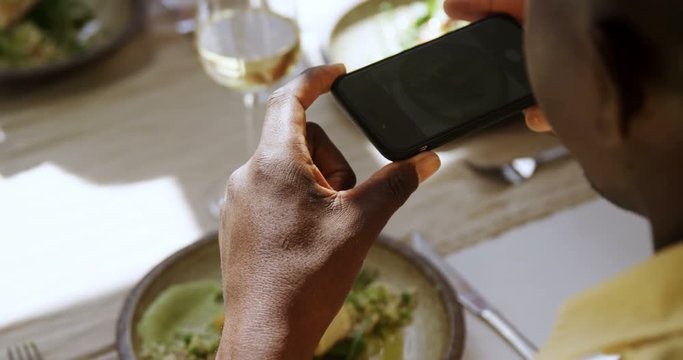 Man taking picture of food from mobile phone