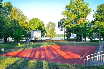 Basketball court over the lake. Place of recreation and leisure.