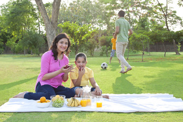 Portrait of mother and daughter with apple
