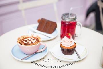 Photography of cakes, cappuccino and cocktail on a table
