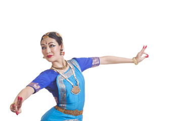 Dancer performing Bharatanatyam against white background