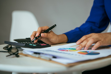 Financial expert reading investment report on her desk