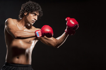 Young man wearing boxing gloves 