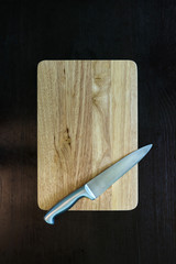 stainless  kitchen knife on wood cutting board